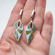 "Weight - 8,3 gr Length - 52 mm/2.04\" (including ear wire) Width - 14 mm/0,55\" Materials - Sterling Silver, Fine Silver, Cloisonne Enamel. Long, dangling, khaki earrings with latch back closure. Latch back ear wires is comfortable to wear, has a safe lock and also made from Sterling Silver. Underneath the enamel layer I made engraving pattern which gives my pieces even more loveliness and charm. Earrings covered with hot enamel. Enamelling is an art of decoration metal surfaces to create color Enameled Jewelry, Cloisonne Earrings, Ammolite Jewelry, Cobalt Blue Earrings, Safe Lock, Long Gold Earrings, Spike Earrings, Feather Jewelry, Free Earrings