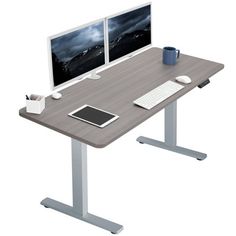 a computer desk with two monitors and a keyboard