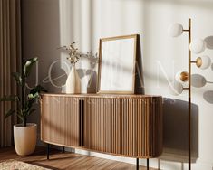 a wooden sideboard with a mirror and vase on it in front of a window