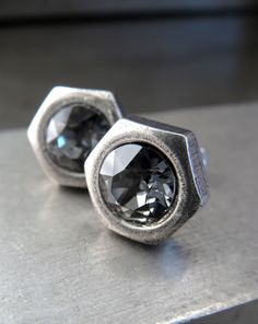 Simple, clean, unisex hex nut earring stud design! Dark, sparkling Swarovski crystals in deep charcoal grey are embedded into hex nut shaped antiqued silver plated bezels. These stud post earrings make a perfect gift for Dad on Fathers Day, boyfriend or fiancee, husband, best man or groomsmen gifts, your fav dude or guy, or your best handy gal. Swarovski crystal rhinestone: 6mm dia (1/4") Antiqued silver hex nut bezels: 3/8" tall by 3/8" wide Plated post: 1/2" long (backings included) Men's Earrings Studs, Unique Mens Earrings, Silver Earrings For Men, Silver Stud Earrings For Men, Cool Earrings For Men, Men’s Earrings Stud, Masculine Earrings, Male Studs Earrings, Black Stud Earrings Mens