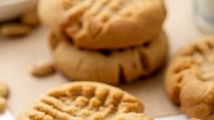 peanut butter cookies are stacked on top of each other, with one cookie missing the middle