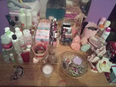 the table is covered with many different types of cosmetics and personal care products on it