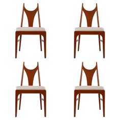 four wooden chairs with white upholstered seats