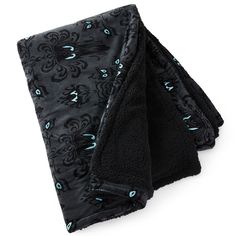 two black towels with blue and green designs on them, one folded up to the side