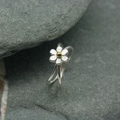 Handcrafted sterling silver flower ring created in our own workshop In Newlyn, Cornwall. A very pretty, handmade six petal flower ring with a single bead to centre. The flower sits between two round silver wires  creating this unique concave design which is very comfortable to wear. The flower measures 10mm and central  bead is available  in silver, copper or brass as shown. UK finger sizes  J to T Other sizes  on request   All my designs are hand made and no two are exactly the same.   Thank you for visiting. All my jewellery comes in a presentation gift box.  Please note that international shipping fees do not include possible custom charges for your country and you will be solely responsible for payment of these charges.  We are required by law to fully disclose the contents and value o Mixed Metal Ring, Wide Silver Ring, Art Nouveau Ring, Mixed Metal Rings, Silver Flower Ring, Crossover Ring, Valentines Earrings, Unusual Rings