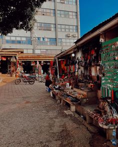 an outdoor market with lots of items on display