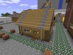 a small wooden house in the middle of a village