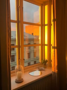 a bathroom window with the sun shining through it's glass panes and windowsills