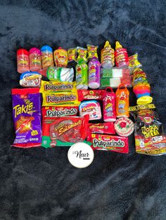 a pile of different types of candy on a blue blanket