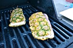 two grilled pineapples sitting on top of a grill with some kind of garnish