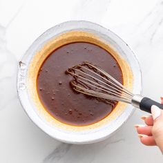 someone is whisking chocolate in a bowl