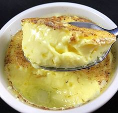 a spoonful of mashed potatoes in a white bowl