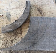 two pieces of wood sitting on top of a wooden table