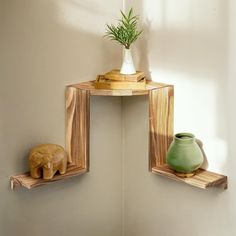 two wooden shelves with vases and an elephant figurine on them