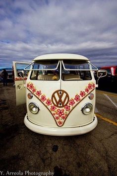 an old vw bus is parked in a parking lot