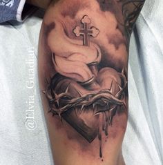 a tattoo on the arm of a person with a cross