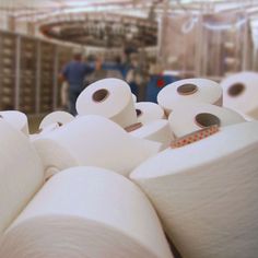 several rolls of toilet paper are stacked on top of each other in a factory room