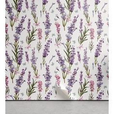 purple flowers on white wallpaper with pink and green leaves in the corner, next to a