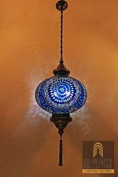 a blue glass light hanging from a ceiling