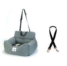 a dog bed with a leash attached to it's side and an empty bag on the other side