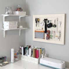 a white desk with some craft supplies on it