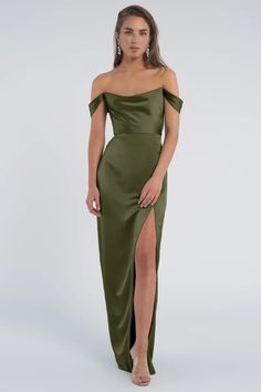 a woman in a green dress with one leg slited