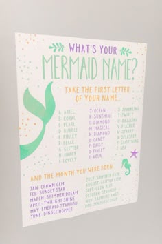 a mermaid themed party game is hanging on the wall with its name written in it