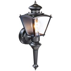 an outdoor wall light with a clear glass shade on the top and bottom half of it