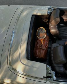 the interior of an old car with a tennis racket in it