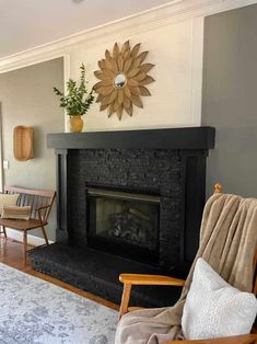 a living room with a fireplace and chairs