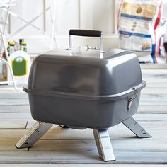 a large gray grill sitting on top of a wooden floor