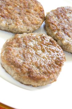 two hamburger patties sitting on top of a white plate