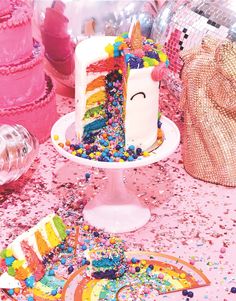 there is a cake on the table with sprinkles and confetti