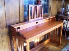 a wooden bench sitting in the corner of a room