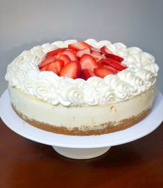 a white cake with strawberries on top