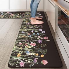 a woman is standing on the kitchen floor with her feet in the oven door mat