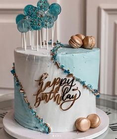 a birthday cake decorated with blue and gold decorations