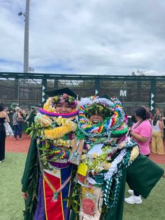 two people dressed up in costume at a baseball game