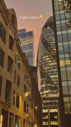 a city street with tall buildings next to each other at dusk and the sun is setting