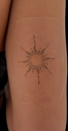 a woman's thigh with a small tattoo on the back of her leg,