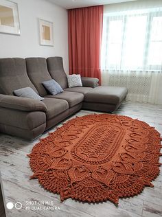 a living room with a large rug on the floor and a couch next to it