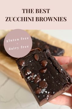 These healthy zucchini brownies are gluten free, dairy free, refined sugar free, low sugar, can be made vegan and high protein, plant based. On a sheet of light brown parchment paper are six dark brownie pieces still in the shape of the loaf pan. Each slice is even and shows inside texture that is fudgey, gooey, and has crisp, firm edges. Topped with thick chocolate chips and flakey sea salt.