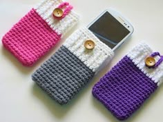 three crocheted cell phones are sitting next to each other with buttons on them