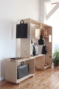 an empty room with several pieces of furniture and bags on the shelves in front of them