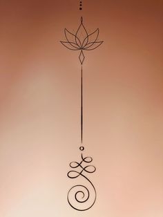 a metal wind chime hanging from the side of a wall with a flower on it