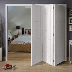 an open white room divider in front of a bed