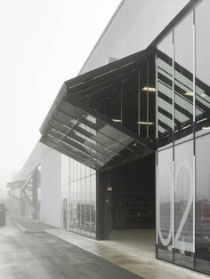 an empty parking garage with the number 20 on it's side and fog in the air