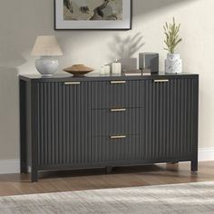 a sideboard with three drawers and two lamps on top of it in a living room