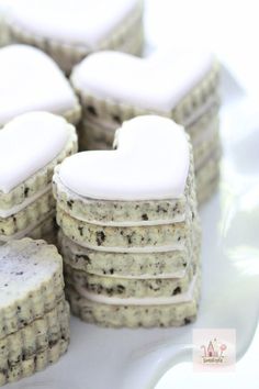 cookies with white frosting in the shape of hearts