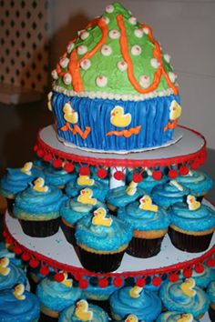 cupcakes are stacked on top of each other in front of a multi - tiered cake